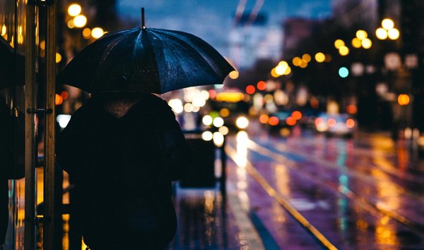 Regenschirm am Abend im Licht der Stadt